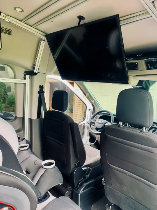 Spacious RV rental interior featuring a large overhead TV and child safety seat, perfect for comfortable family travel.. Vandoit Vandoit Class B 2020
