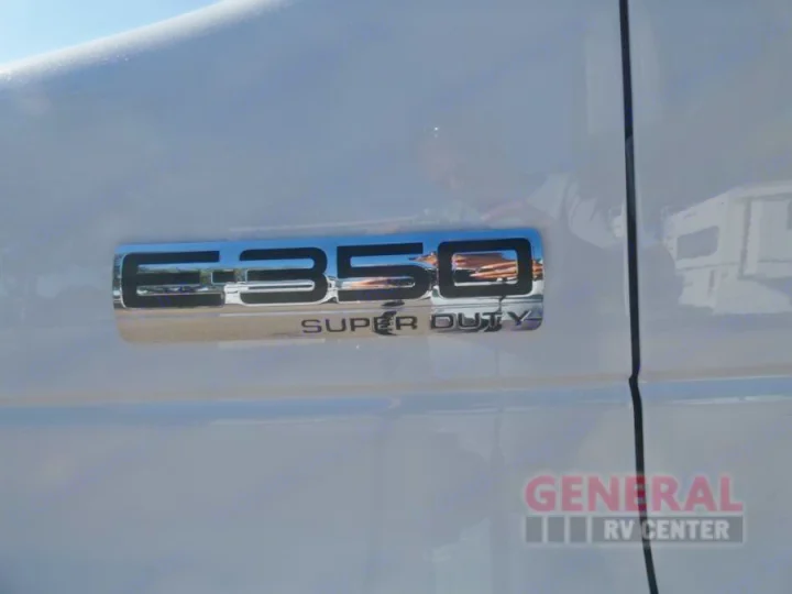 Close-up of the chrome 'E-350 SUPER DUTY' emblem on a white Ford RV, perfect for your next rv rental adventure.. Forest River Coachmen Cross Trail XL 2022