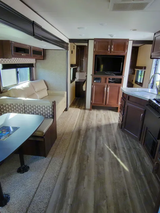 Explore this well-appointed RV rental interior, featuring a modern kitchen, comfortable dining, and living space.. Jayco Jay Flight 2020