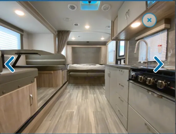 Spacious RV rental interior featuring a full kitchen, comfortable dinette, and cozy bed area for your adventures.. Winnebago Minnie 2022