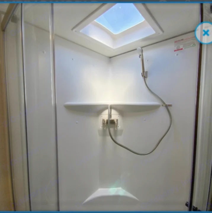 Clean and compact RV rental shower with a bright skylight. Perfect for comfortable travel adventures on the road.. Winnebago Minnie 2022