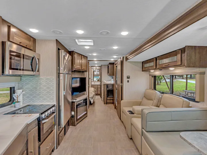 This RV rental offers a spacious, modern interior with a full kitchen and comfortable living area, perfect for travel.. Coachmen Mirada 2021