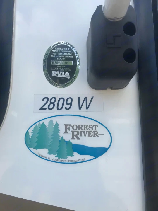 Detail of a Forest River rv rental, showing its RVIA safety certification seal and model 2809 W for compliance.. Forest River Rockwood Windjammer 2012