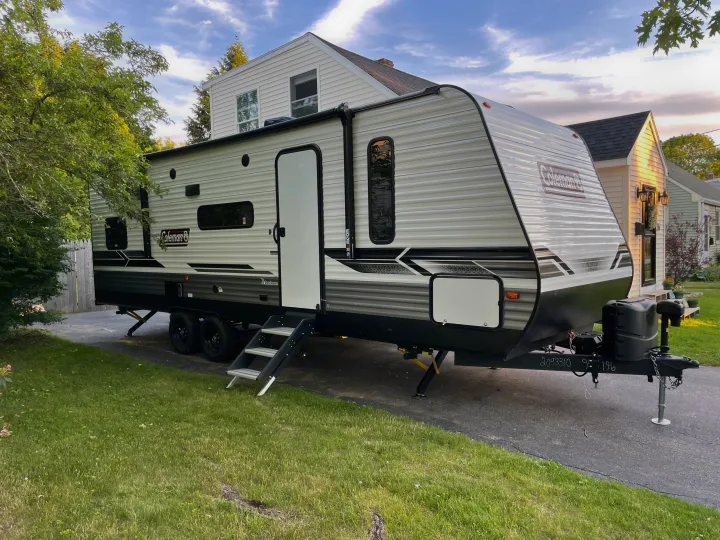 Large Coleman travel trailer parked on a driveway, ready for your RV rental adventure or family camping trip.. Coleman 263BH 2022