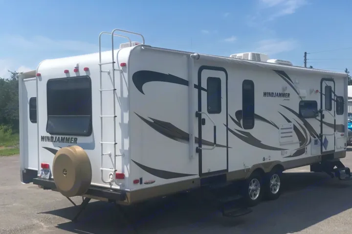 White Windjammer travel trailer, ideal for RV rental and outdoor adventures.. Forest River Rockwood Windjammer 2012