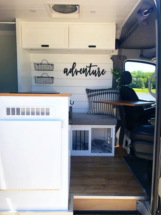 This cozy RV rental's custom-built camper van interior features overhead storage, a dog kennel, and a seating area for your adventures.. Mercedes-Benz Sprinter 2015