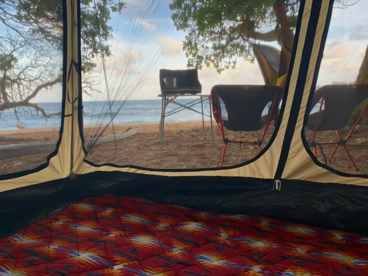 Inside tent: cozy mat. Outside: beach camp setup with stove, chairs, ocean view. RV rental offers similar outdoor adventures!. Toyota 4runner 2003