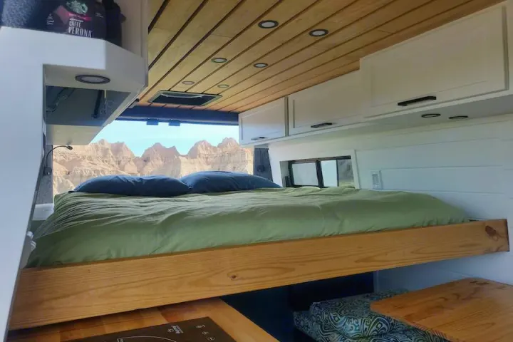 Experience van life! This rv rental offers a comfortable bed, wood interior, & panoramic window view of rugged mountains.. Dodge Promaster 2500 2021