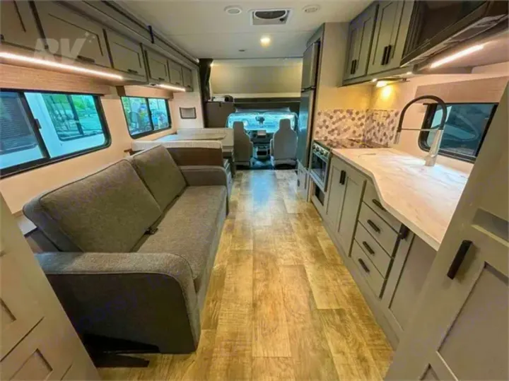 Open floor plan rv rental featuring a living area with sofa, kitchen, and front cockpit. Modern and inviting.. Forest River Solera 2022