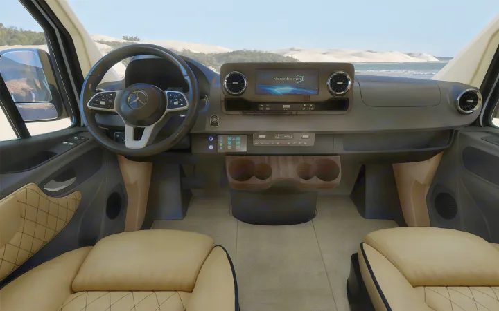 Mercedes-Benz RV interior with modern dash, steering wheel, and tan seats, facing a beach landscape. Perfect for rv rental.. Ultimate Toys Ultimate Traveler 2023