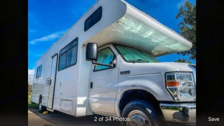 White Class C RV rental parked outdoors under a bright blue sky. Perfect for your next adventure!. Thor Majestic 2016