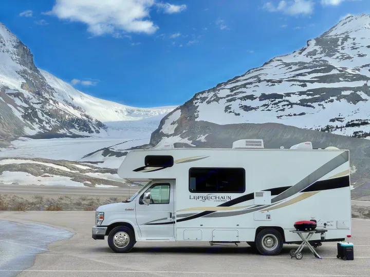 RV rental parked before a majestic glacier and snow-covered mountains. Ideal for scenic adventures and exploring nature.. Forest River Coachmen Leprechaun 2014