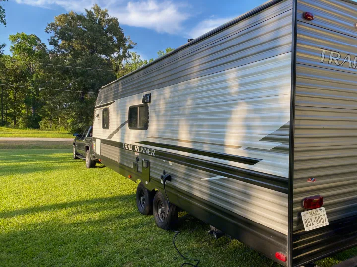 Spacious RV rental, a "Trail Runner" travel trailer, parked on a sunny Texas lawn, ready for adventure.. Heartland RVs Trailrunner 2021
