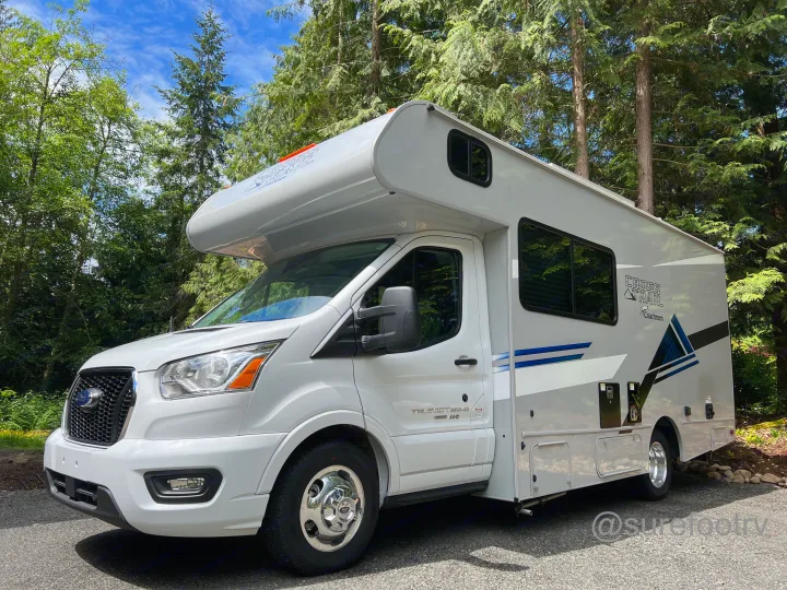 White Coachmen Cross Trail Class C RV rental parked in a sunny forest. Perfect for your next road trip adventure.. Forest River Coachmen Cross Trail XL 2022