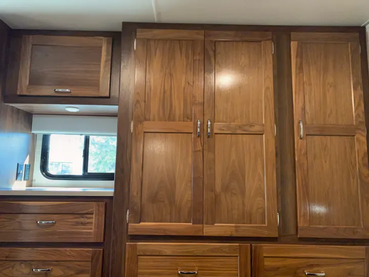 RV rental interior: elegant wooden cabinets, drawers, and chrome hardware for ample storage and comfortable travel.. Winnebago Outlook 2020