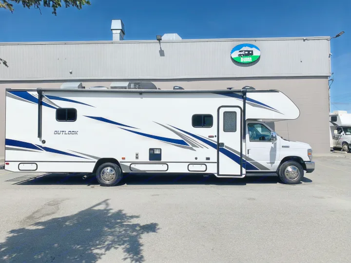 An "Outlook" rv rental, a white Class C motorhome, parked at Alaska RV Rentals. Bright day for an Alaskan adventure.. Winnebago Outlook 2020