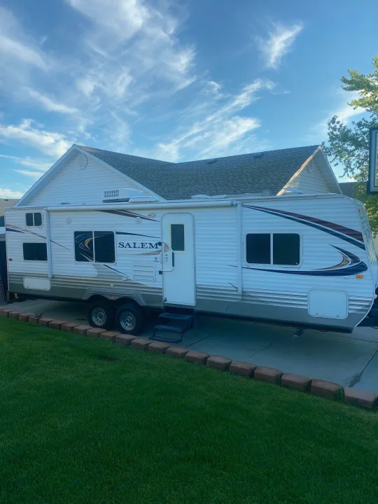 Salem travel trailer, perfect for RV rental adventures, parked at home on a concrete driveway with green lawn.. Forest River Salem 2011