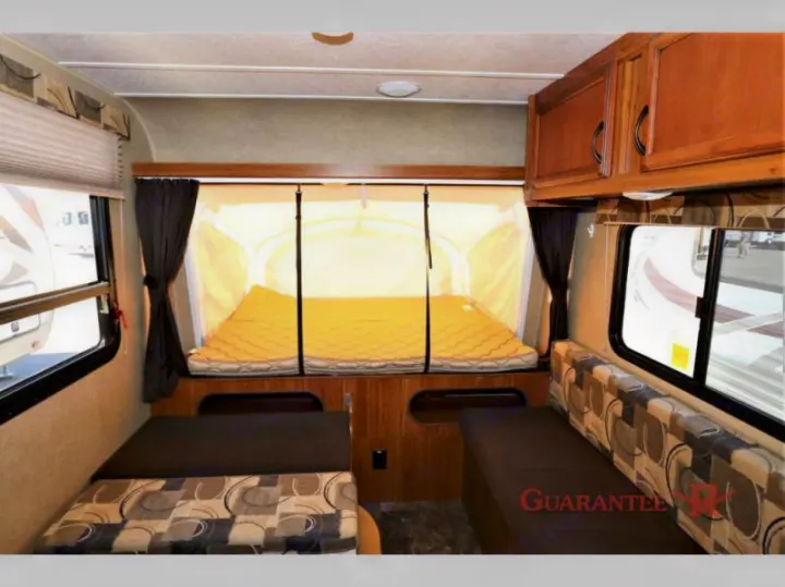 Spacious RV rental interior with a cozy pop-out bed and comfortable seating, ideal for travel adventures.. Starcraft Launch 2016