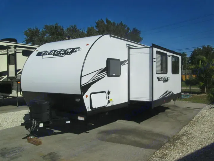 White Tracer LE travel trailer with slide-out extended, a great option for RV rental.. Forest River Tracer 2022