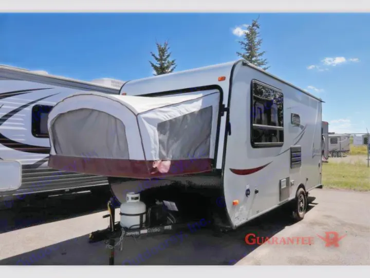 Light gray hybrid travel trailer with tent extension. Ideal RV rental for camping and outdoor adventures.. Starcraft Launch 2016