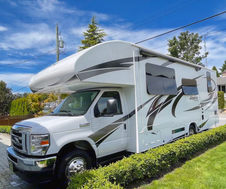 A white Jayco Redhawk Class C RV rental, parked on a sunny day, ready for travel adventures.. Jayco Redhawk 2021