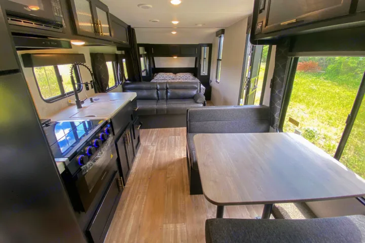Modern RV rental showcasing a full interior with kitchen, dining, comfortable living space, and bedroom. Ready for adventures!. Forest River Cherokee Greywolf 2022