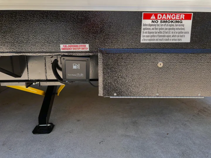 RV rental's external fuel dispensing panel, featuring pump controls, an emergency shutoff, and safety warnings. A leveling jack is visible below.. Forest River Shockwave 2022