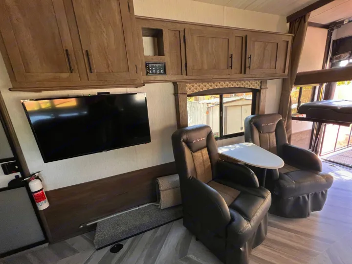 This RV rental's inviting interior features comfy recliners, TV, and ample storage, ready for your travels.. Forest River Shockwave 2022