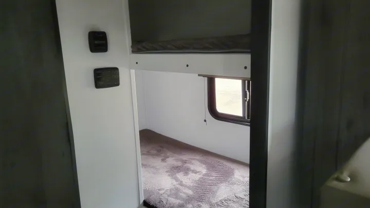 Inside this cozy RV rental, you'll find bunk beds, a window for views, and convenient control panels for comfort.. Keystone Hideout 2022