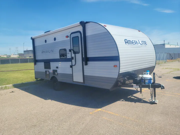Side view of a white and gray Ameri-Lite travel trailer, perfect for your RV rental needs.. Gulf Stream Ameri-Lite Super Lite 2021