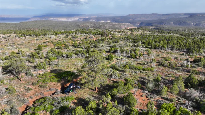 Experience outdoor adventure! An RV rental-ready truck with a rooftop tent is parked amidst trees in a vast, scenic landscape.. Toyota 4Runner 2013