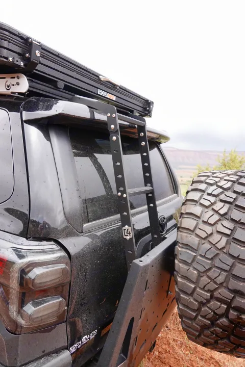 RV rental-ready SUV with Roofnest tent, ladder, & spare tire. Perfect for dusty off-road camping adventures.. Toyota 4Runner 2013