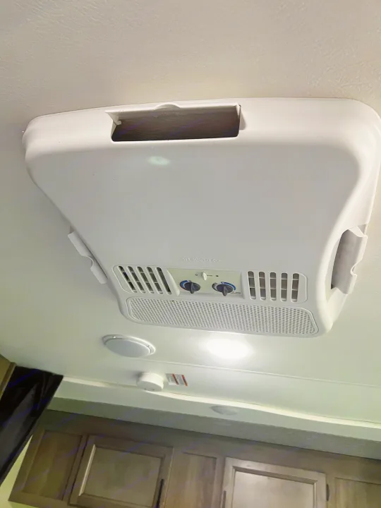 RV rental interior: A Dometic ceiling AC unit with visible controls, alongside RV lights and vents, ensuring comfort on the road.. Open Range Open Range 2022