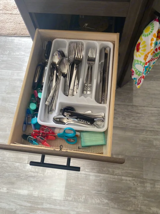 Open RV rental kitchen drawer: organized silverware, bottle opener, scissors, and colorful clothes pins.. Prime Time Avenger 2021