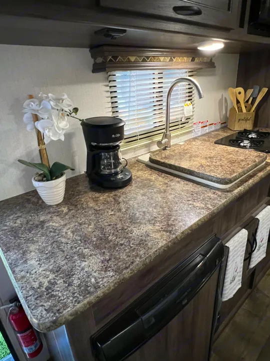 RV rental kitchen: Mr. Coffee maker, sink, stovetop, Dometic fridge, and ample counter space.. Pacific Coachworks Pacifica XL 2020