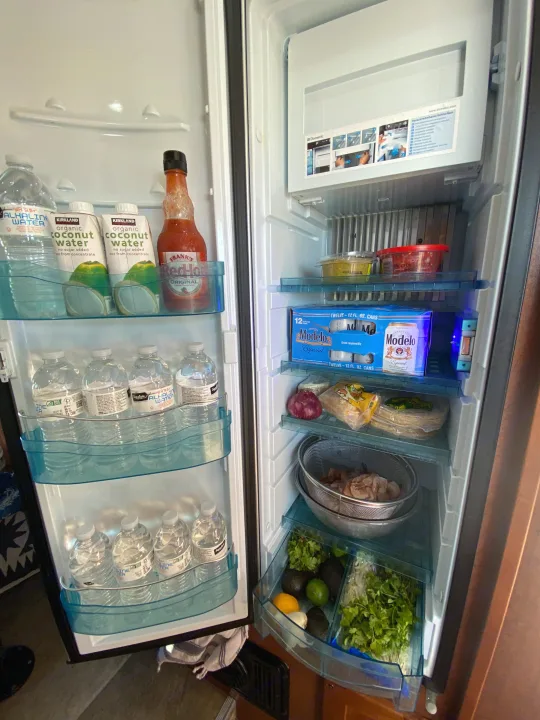This **rv rental** fridge is well-stocked with drinks, hot sauce, shrimp, and fresh taco ingredients like avocados, cilantro, and tortillas.. Pleasure-Way Pleasure-Way Class B 2016