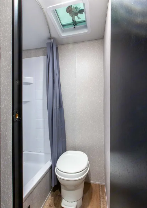 RV rental: This compact bathroom has a shower/tub, toilet, and ceiling vent with a fan for comfort.. Forest River Cherokee Wolf Pup 2022