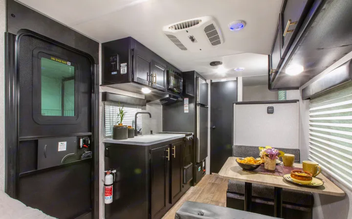 Compact RV rental interior with full kitchen, dinette, and amenities for comfortable travel.. Forest River Cherokee Wolf Pup 2022