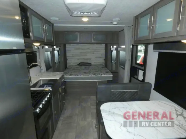 Explore this rv rental's modern interior: full kitchen, dinette, and queen bed. Perfect for travel.. Dutchmen Kodiak Ultra Lite 2021