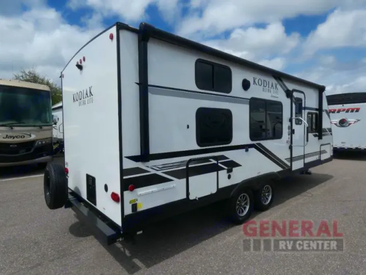 This white Kodiak Ultra Lite travel trailer RV rental offers comfort for camping trips, with dual axles and an awning.. Dutchmen Kodiak Ultra Lite 2021
