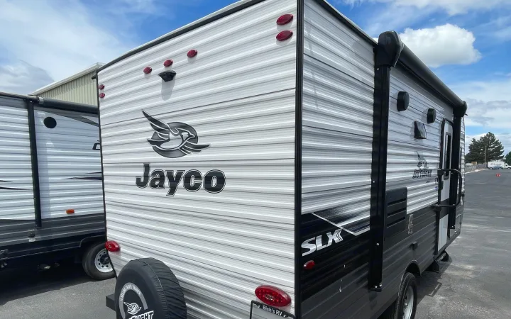 Modern Jayco travel trailer, ideal for rv rental. View shows the sleek white and black RV's rear and side.. Jayco Jay Flight SLX 7 184BS 2022
