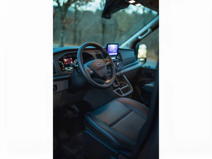 This image shows the spacious cockpit of a modern Ford van, ready for your RV rental adventure.. Ford Transit 2021
