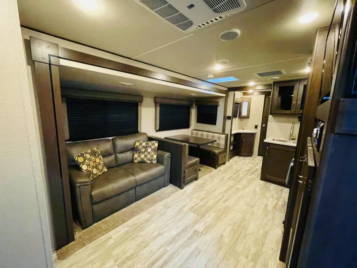 Modern RV rental interior: spacious living area, dinette, kitchen, & bath. Perfect for travel adventures.. Grand Design Transcend 2020