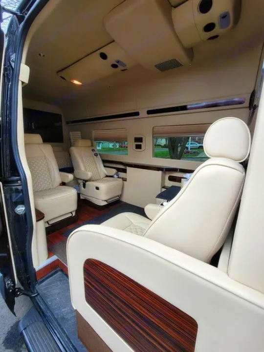 Explore the comfort of this RV rental, featuring cream leather seats, wood accents, and ample windows for luxurious journeys.. Mercedes-Benz Sprinter 2016