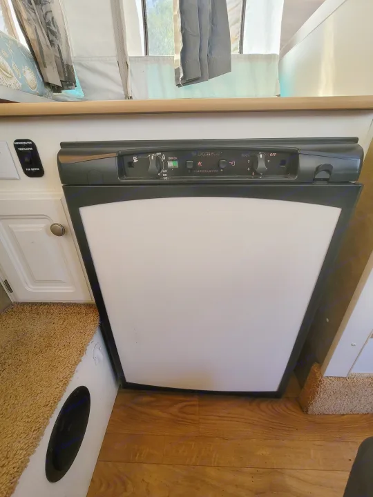 RV rental Dometic refrigerator, showing detailed controls & fan switch for optimal cooling.. Starcraft Centennial 2005