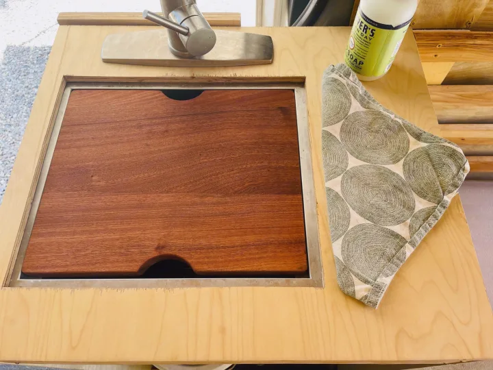 This RV rental features a compact kitchen with a covered sink/cutting board, faucet, soap, and dishtowel for efficient space.. Dodge Sprinter Van 2007