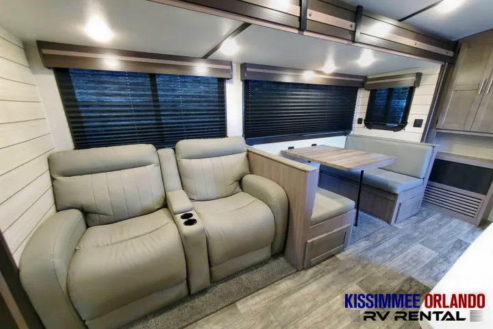 Explore this comfortable RV rental interior: recliners with cup holders, a dinette, and ample living space for your journey.. Crossroads Sunset Trail 2022