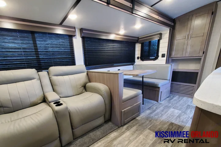 Spacious RV rental living area with comfortable recliners, a dinette, and ample storage. Ready for travel!. Crossroads Sunset Trail 2022