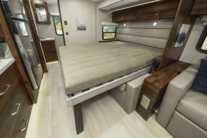 Step inside this RV rental: a modern, light-filled interior with a clever convertible bed, compact kitchen, and cozy lounge.. Winnebago View 2025