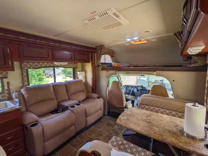 Comfortable RV rental living space: recliners, dinette, overhead bunk, and full kitchen. Perfect motorhome getaway.. Thor Four Winds 2013